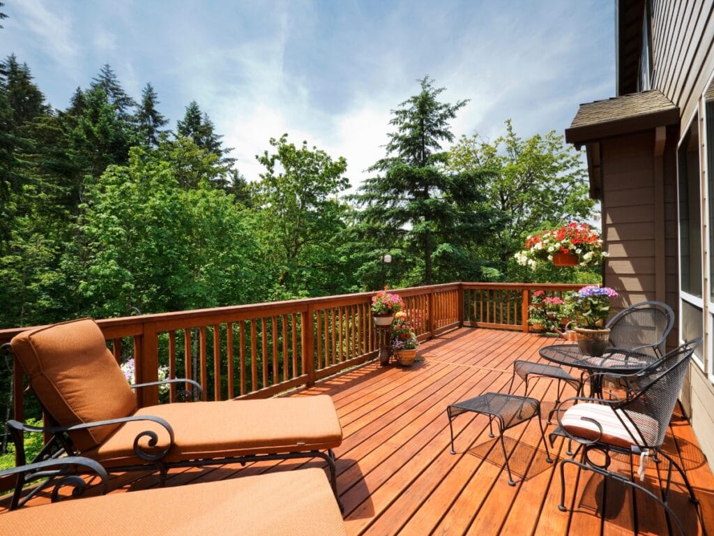 A deck with chairs and a table, crafted from quality deck materials for lasting comfort and style.